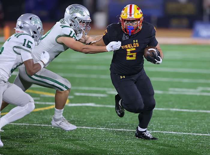 Mission Viejo's Hinesward Lilomaiava is grabbed by De La Salle's Drew Cunningham.